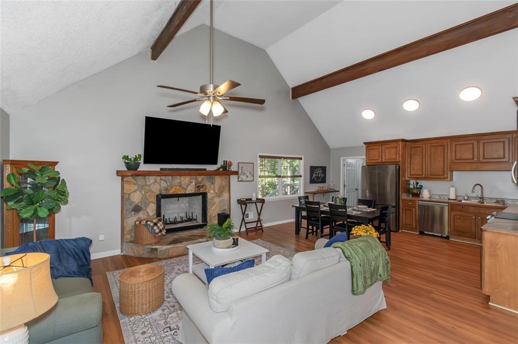 150 Mackey Road McDonough, GA 30252 - Photo 10 of 38 a living room with furniture a fireplace and a flat screen tv