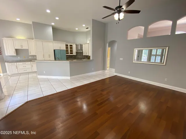 a view of kitchen with windows and ceiling fan