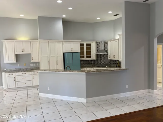 a kitchen with a sink a microwave and cabinets