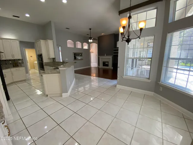 a kitchen with stainless steel appliances kitchen island granite countertop a refrigerator and a sink