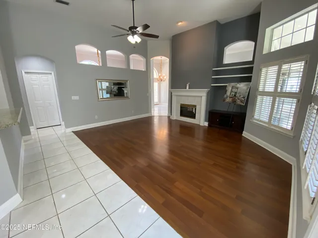 a view of a kitchen with furniture and wooden floor