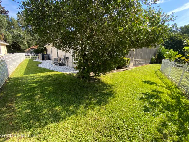 a view of a house with backyard and porch
