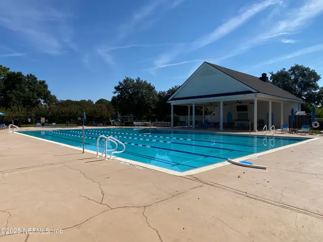 a view of a grassy field with trees