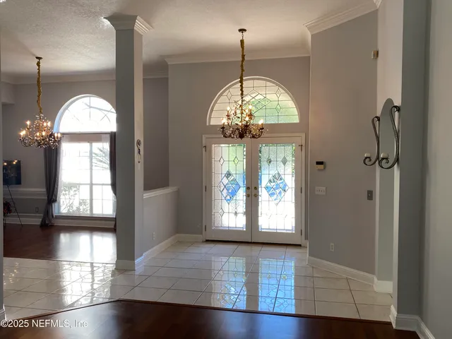 a view of empty room with wooden floor and window