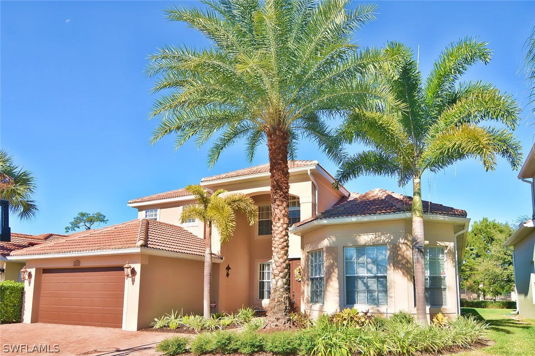 12357 Rock Ridge Lane Fort Myers, FL 33913 - Photo 1 of 25 a front view of a house with a yard