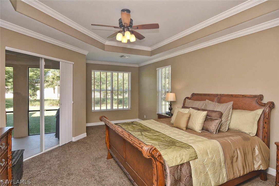 12357 Rock Ridge Lane Fort Myers, FL 33913 - Photo 16 of 25 a bedroom with a large bed and a chandelier