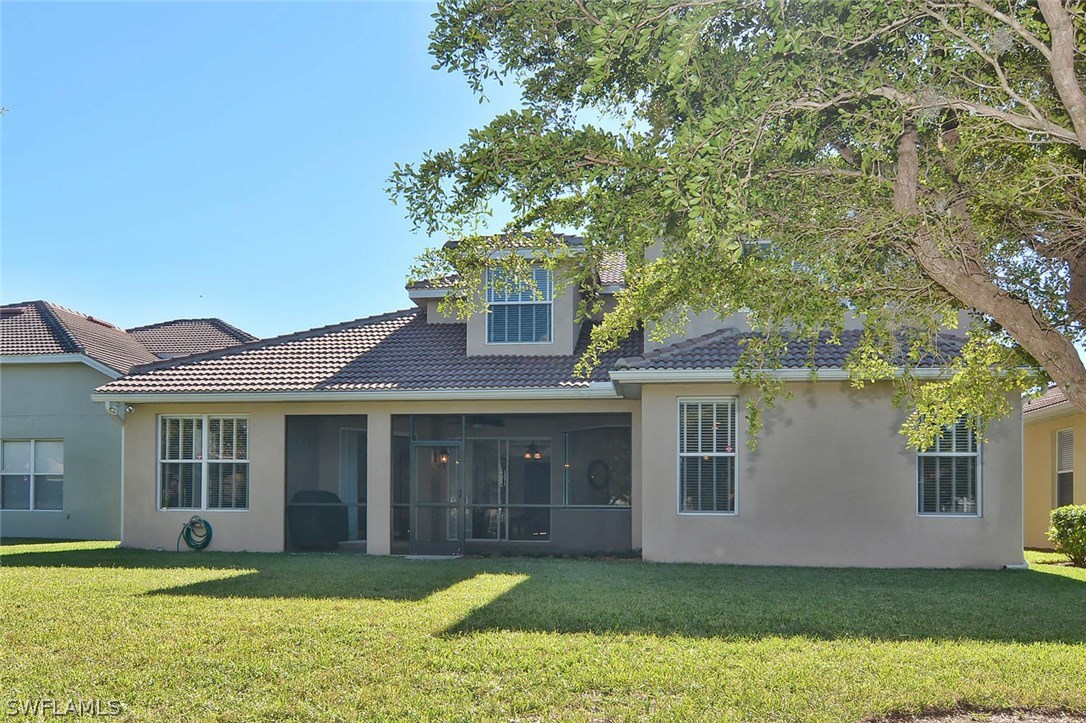 12357 Rock Ridge Lane Fort Myers, FL 33913 - Photo 25 of 25 a front view of a house with a garden and yard