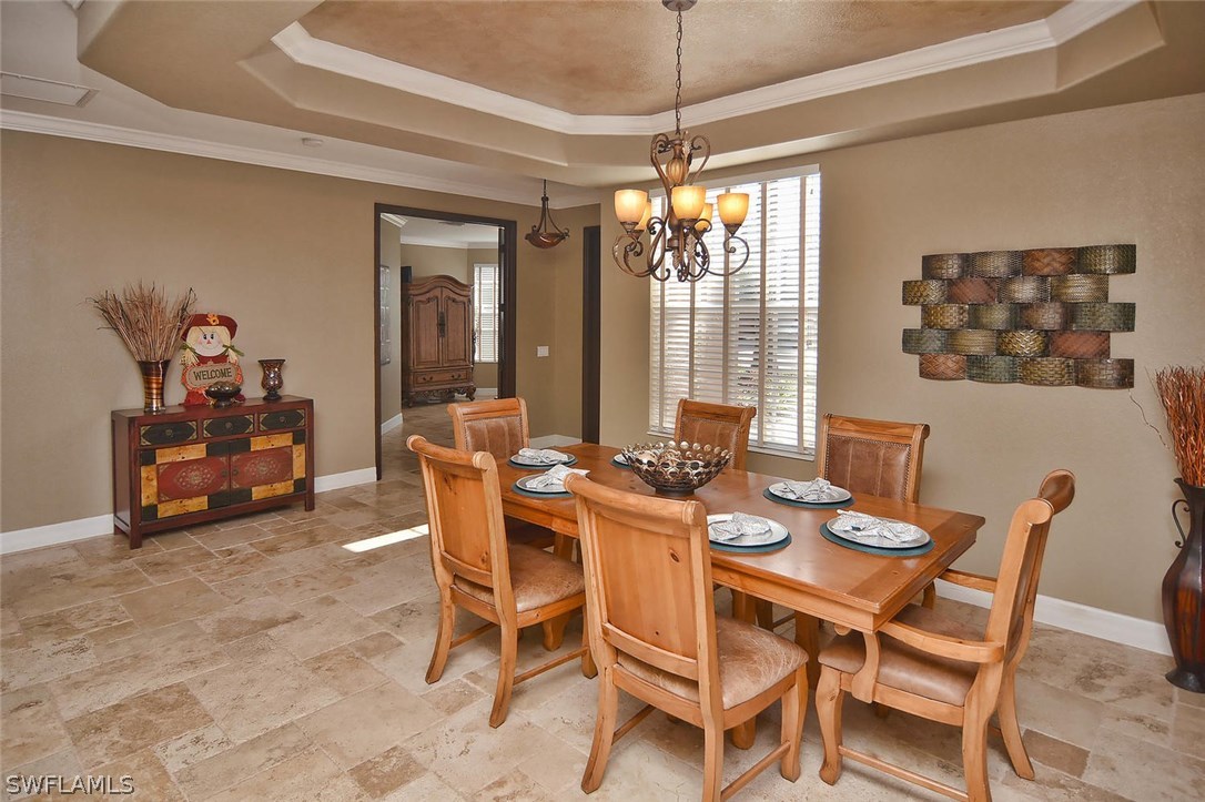 12357 Rock Ridge Lane Fort Myers, FL 33913 - Photo 4 of 25 a view of a dining room with furniture and chandelier