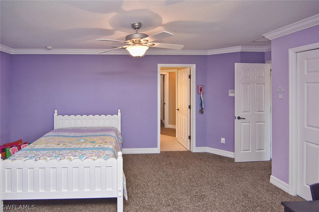 12357 Rock Ridge Lane Fort Myers, FL 33913 - Photo 7 of 25 a bedroom with a bed and a chandelier