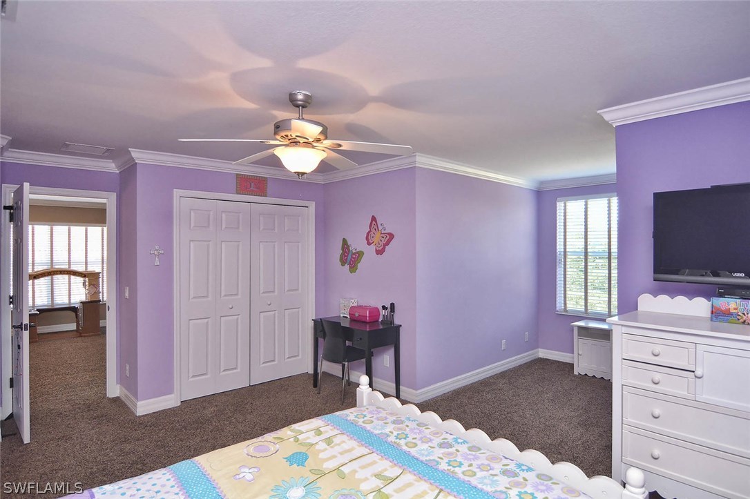 12357 Rock Ridge Lane Fort Myers, FL 33913 - Photo 8 of 25 a bedroom with a bed and a flat screen tv