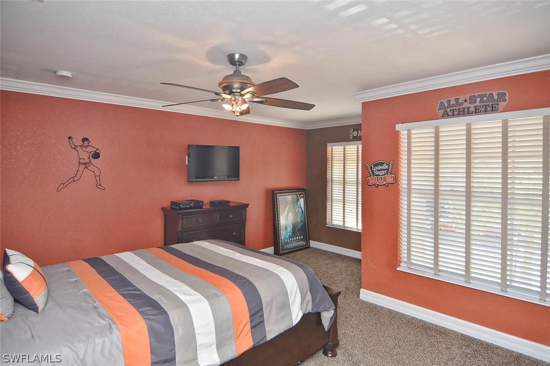 12357 Rock Ridge Lane Fort Myers, FL 33913 - Photo 10 of 25 a bedroom with a large bed and a tv