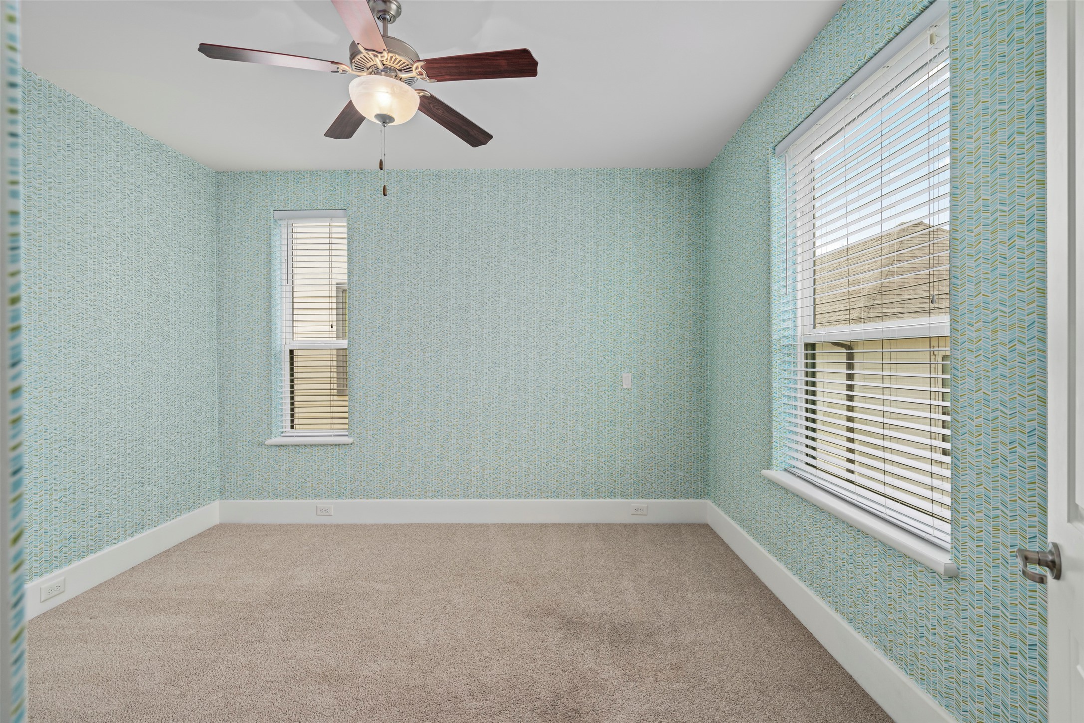 5646 Larkin Street Houston, TX 77007 - Photo 16 of 29 A spacious secondary bedroom, previously used as a nursery, with playful wallpaper that brings in a charming layer of character.