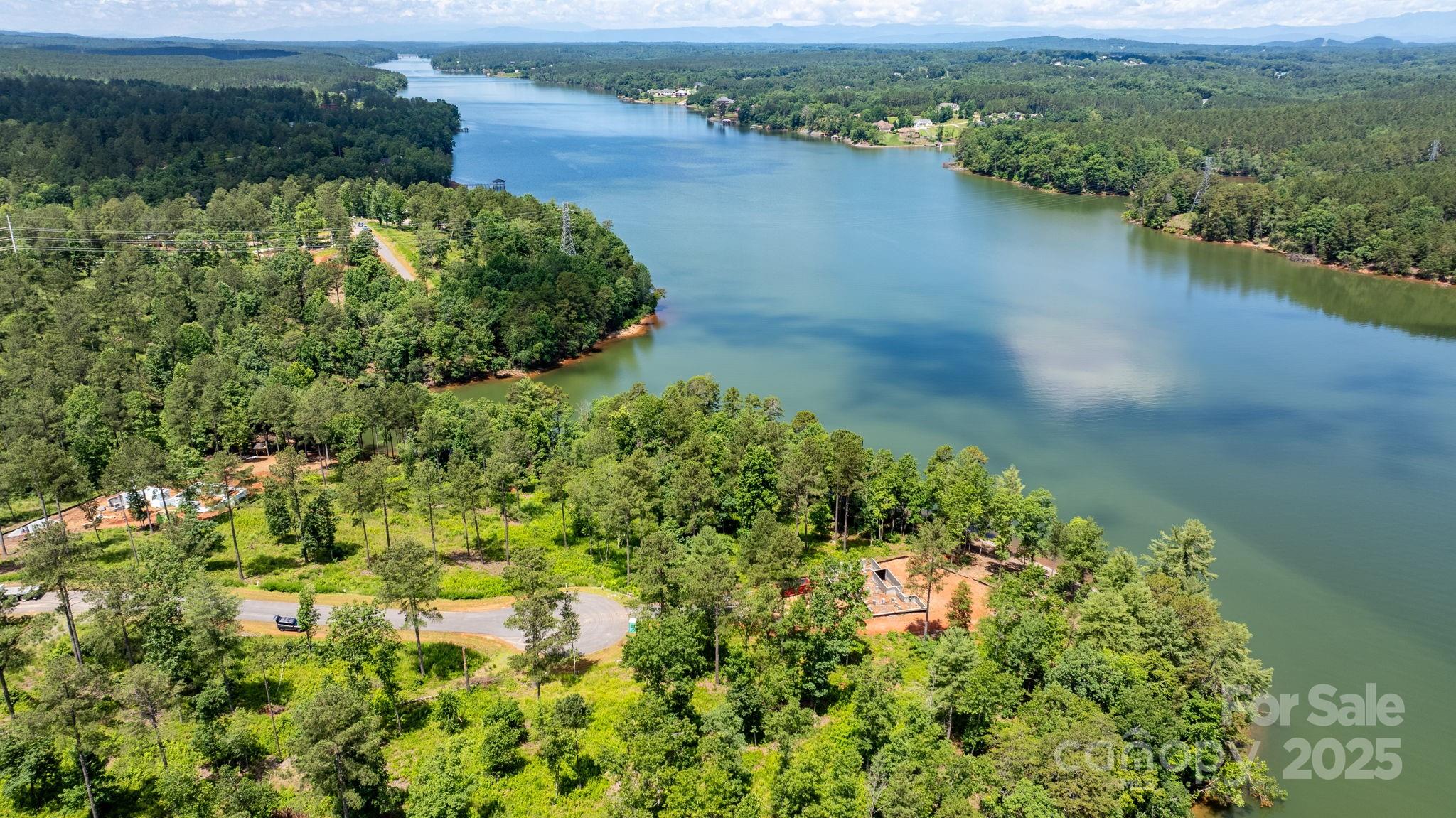 3085 Jumping Run, Unit 101 Connelly Springs, NC 28612 - Photo 11 of 17 an aerial view of a houses with a yard and lake view