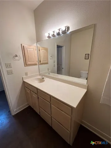 a front view of a house with a garden and trees