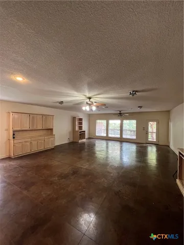 a kitchen that has a sink stainless steel appliances wooden floor and a window
