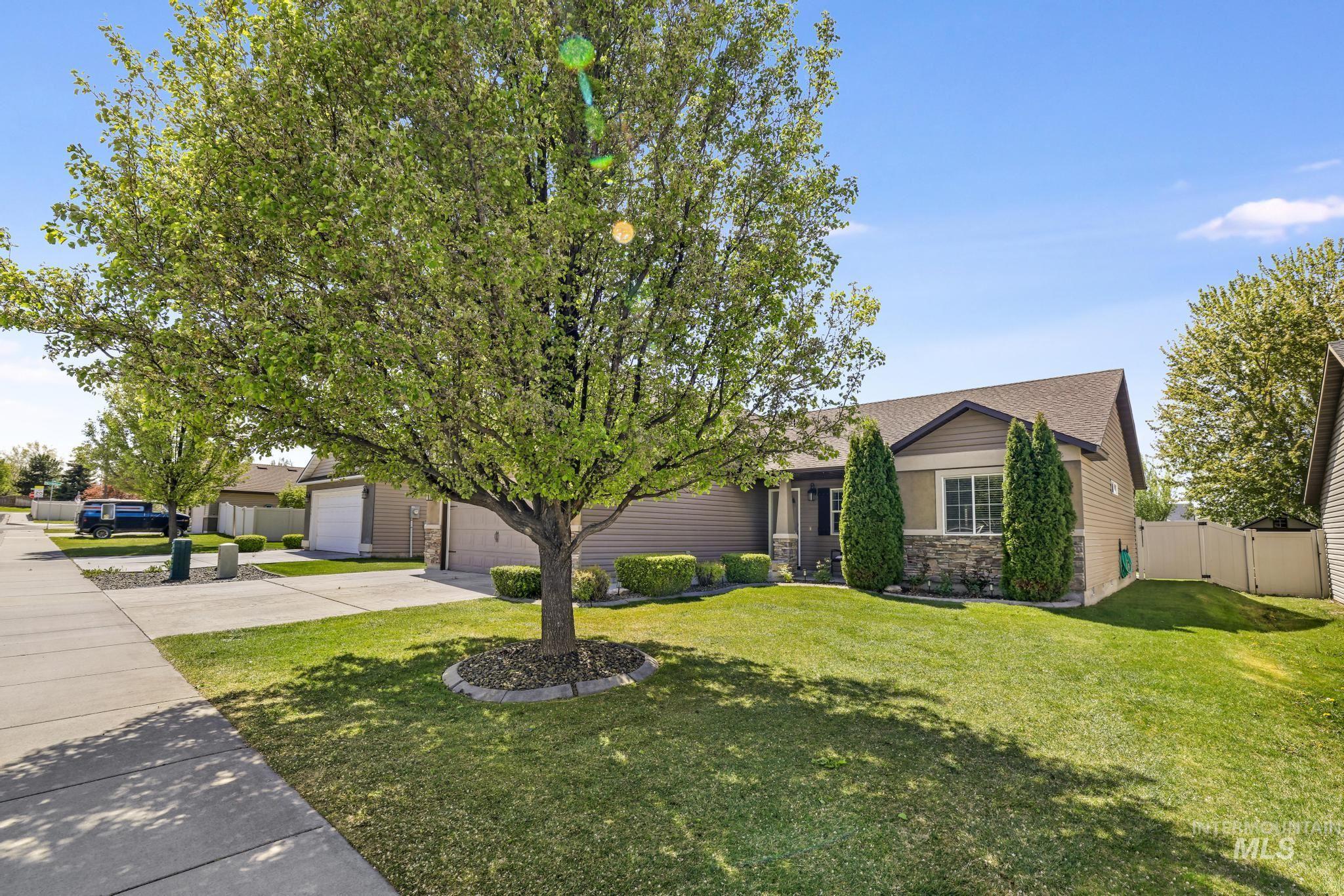 446 Noble Street Twin Falls, ID 83301 - Photo 3 of 42 Front exterior with beige siding, stone facade accents, a gabled roof, and an attached garage