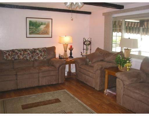 3896 Willett Road Baldwin, PA 15227 - Photo 2 of 7 Living Room. Pretty exposed hardwood floors. Neutral colored walls, beamed ceiling and ceiling fan. Opens to dining room.