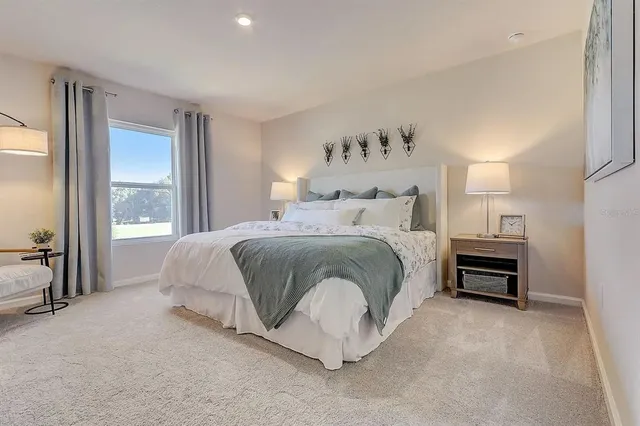 a bedroom with a bed and a large window