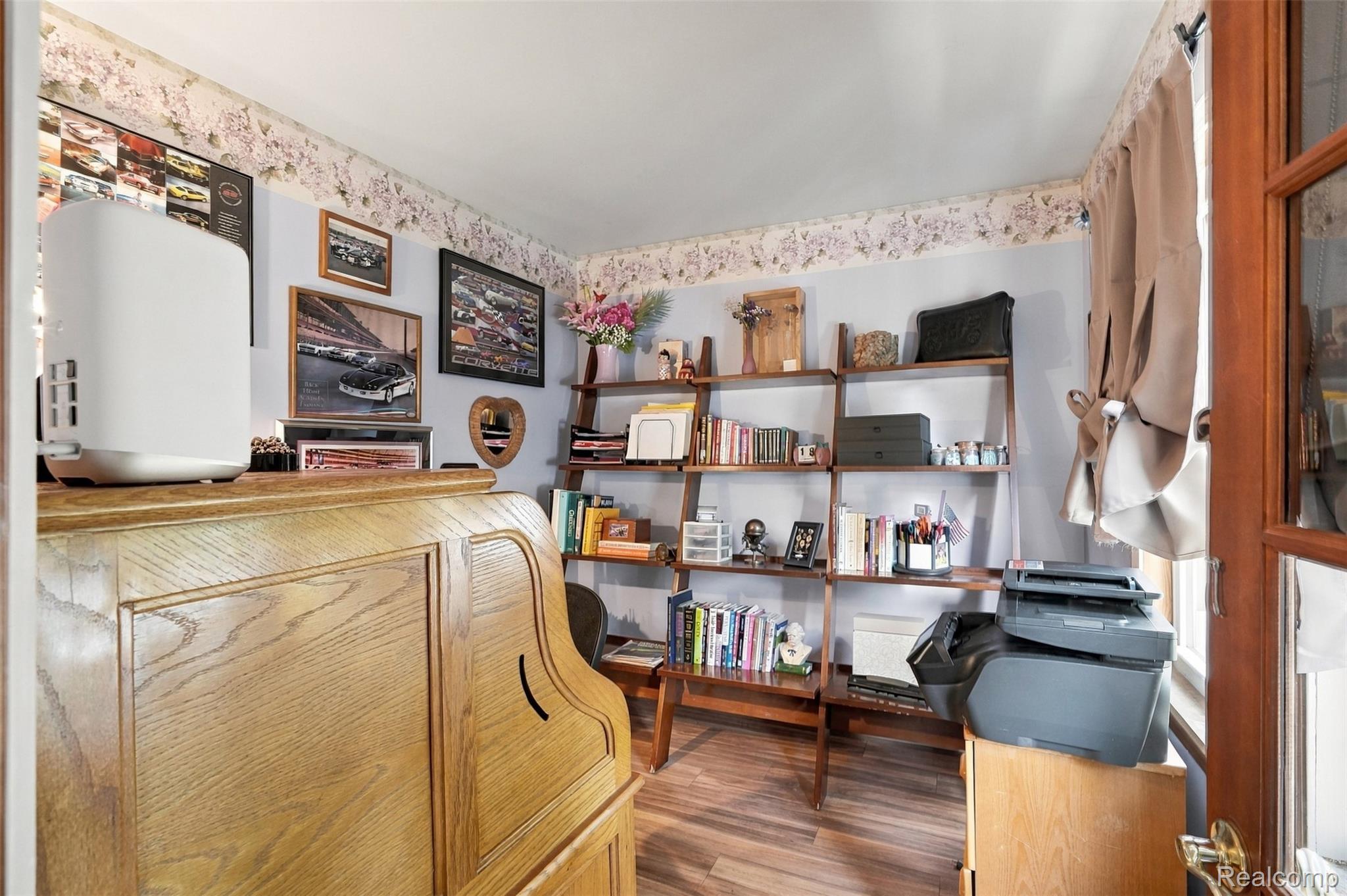 36739 Wick Road Romulus, MI 48174 - Photo 24 of 56 Wood-finish flooring with a decorative wallpaper border and built-in wood shelving