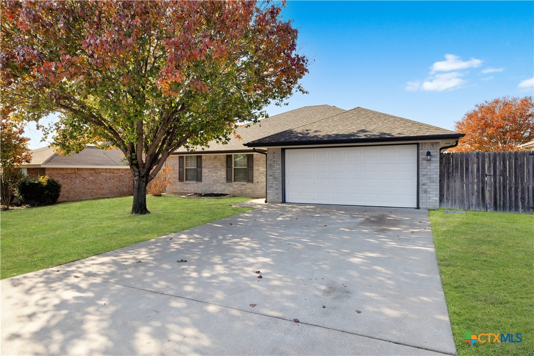217 Timber Ridge Drive Nolanville, TX 76559 - Photo 2 of 25 a front view of a house with a garden and yard