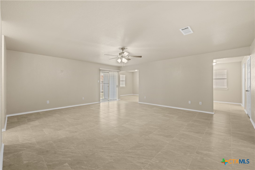217 Timber Ridge Drive Nolanville, TX 76559 - Photo 5 of 25 an empty room with chandelier and windows