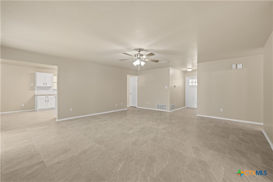 217 Timber Ridge Drive Nolanville, TX 76559 - Photo 6 of 25 a view of an empty room with a ceiling fan