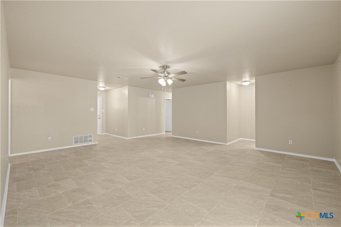 217 Timber Ridge Drive Nolanville, TX 76559 - Photo 7 of 25 a view of an empty room with a ceiling fan