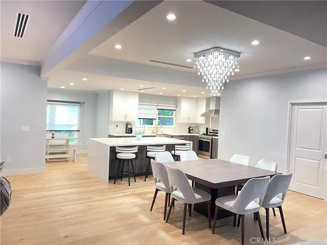 a large kitchen with a table and chairs