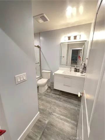 a bathroom with a sink a toilet and mirror