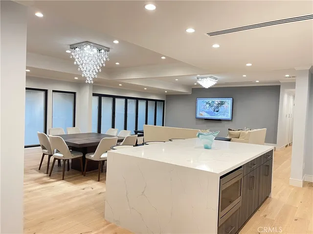 a view of a dining room with furniture and chandelier