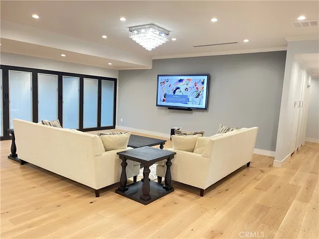 a living room with couches and a flat screen tv