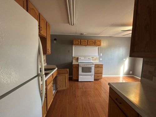 245 Robinson Drive Morris, IL 60450 - Photo 9 of 12 a kitchen with stainless steel appliances granite countertop a refrigerator a stove and a wooden floors
