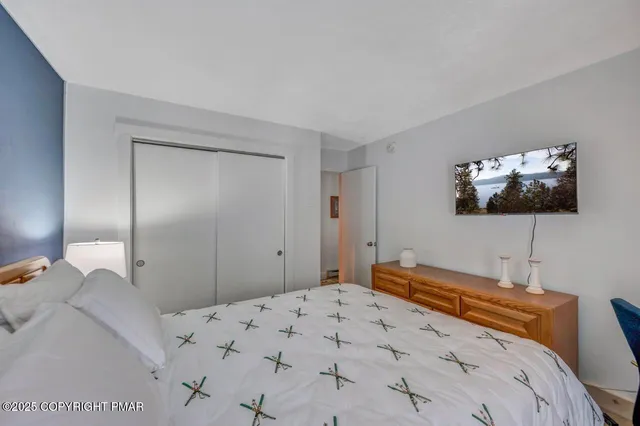 a bedroom with a bed and a flat screen tv