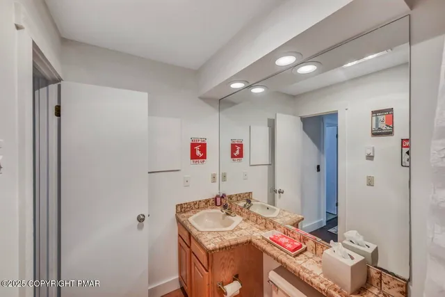 a bathroom with a sink vanity and a mirror