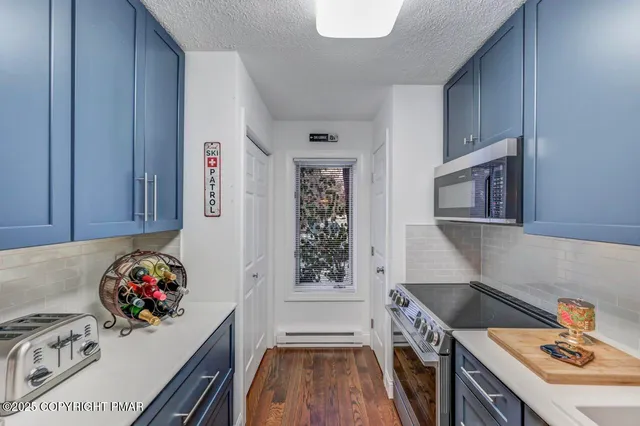 a kitchen with a stove a sink and a microwave