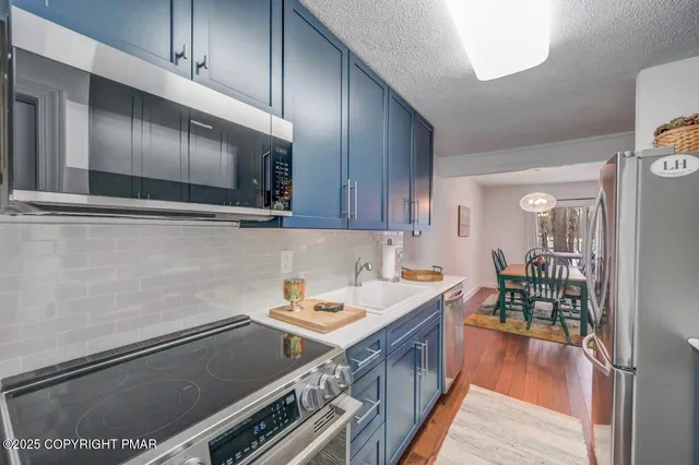 a kitchen with a stove and a refrigerator