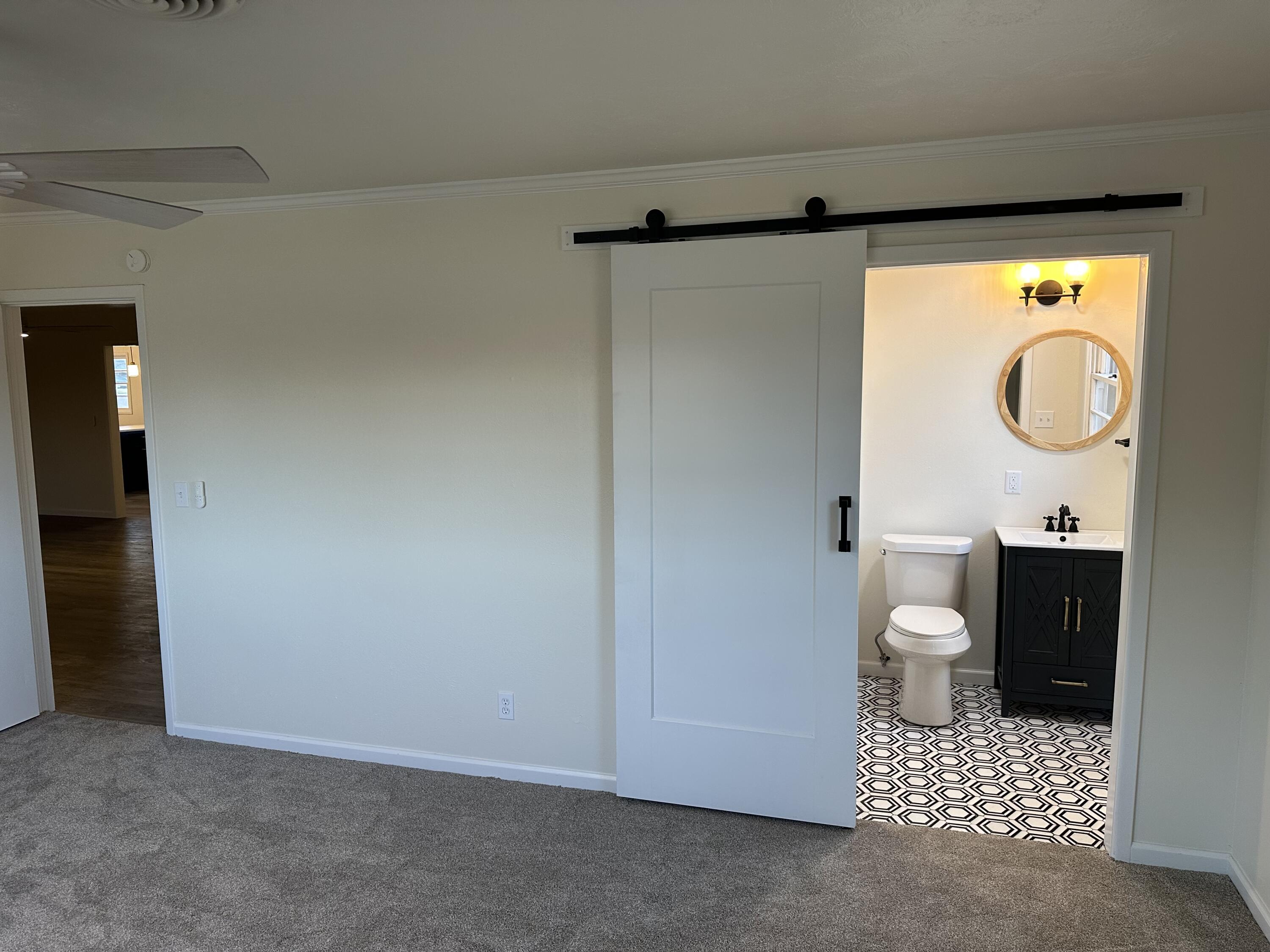 102 Northeast 25th Street Lamesa, TX 79331 - Photo 14 of 32 a bathroom with a toilet a sink and a shower