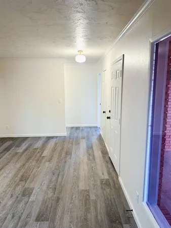 a view of a room with wooden floor