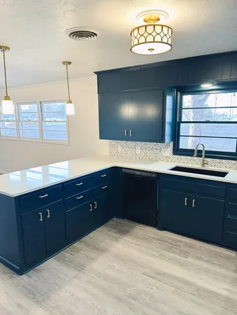 a spacious bathroom with a granite countertop sink and a mirror