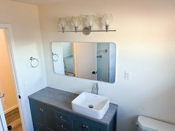 an empty room with fan and entrance