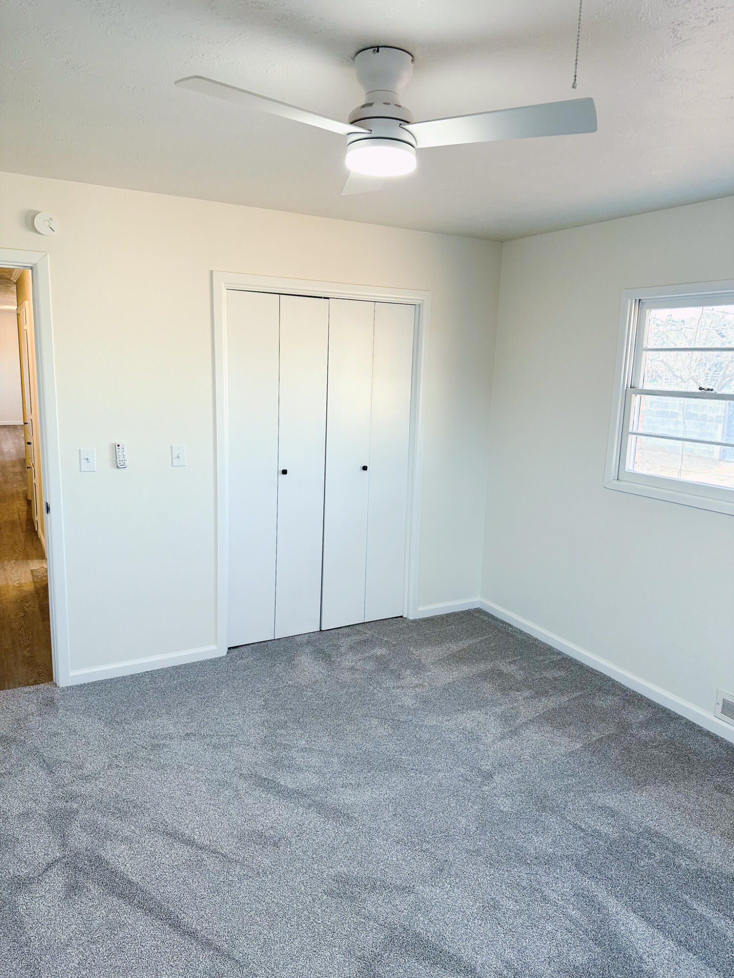 102 Northeast 25th Street Lamesa, TX 79331 - Photo 27 of 32 an empty room with windows and fan
