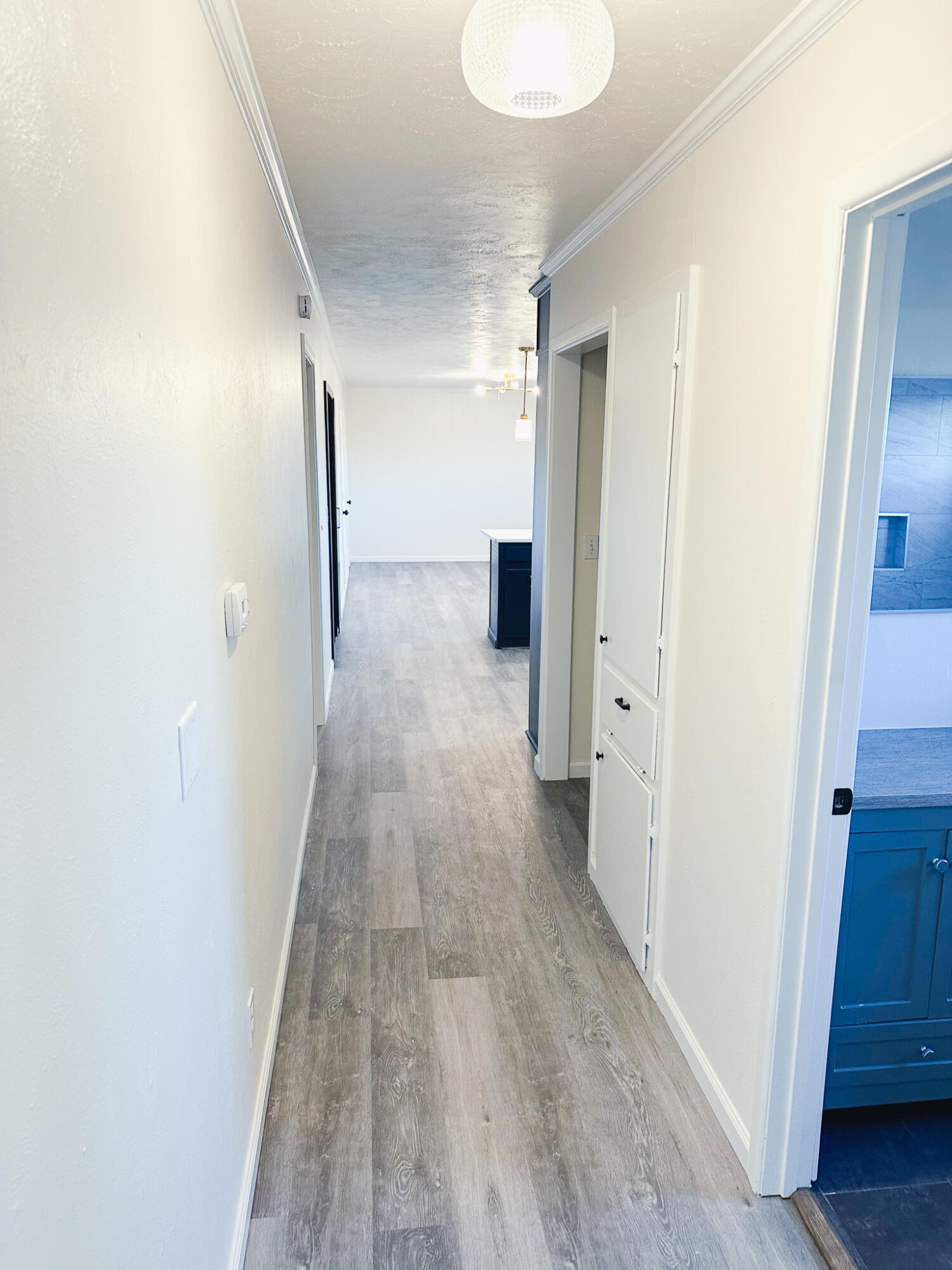 102 Northeast 25th Street Lamesa, TX 79331 - Photo 29 of 32 a view of a hallway with wooden floor