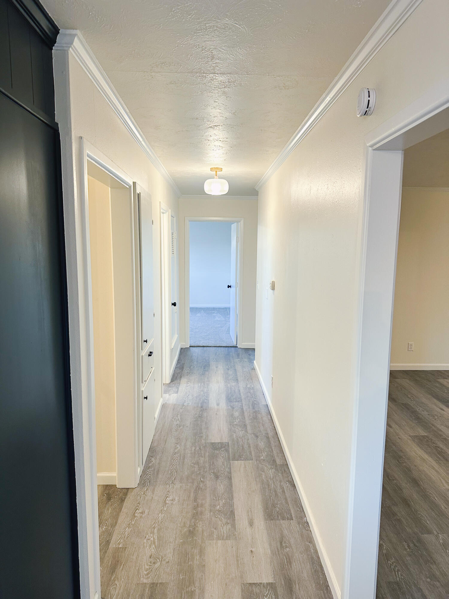 102 Northeast 25th Street Lamesa, TX 79331 - Photo 30 of 32 a view of a hallway with wooden floor