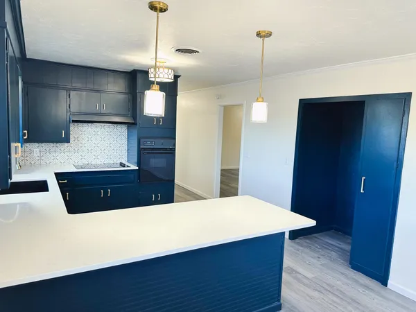 a view of kitchen with cabinets and wooden floor