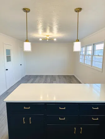 a room with wooden cabinets and window