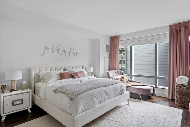 a bedroom with a bed and a large window