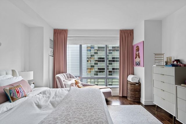 a bedroom with furniture and a large window