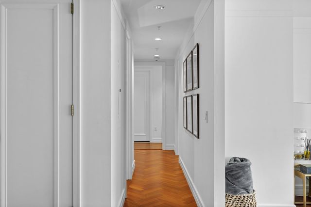 a view of a hallway with closet and front door