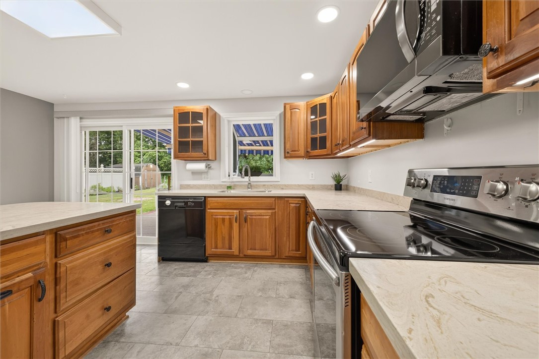 25 Whippletree Road Perinton, NY 14450 - Photo 18 of 44 Eat-in kitchen with Corian counters and an island