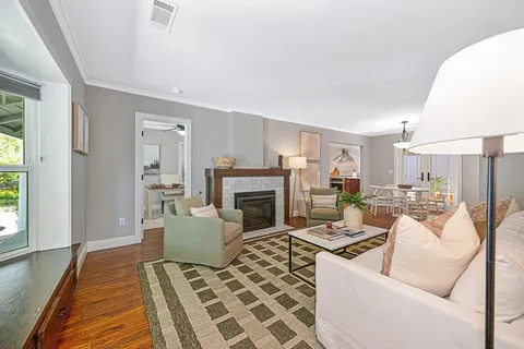 a living room with furniture a fireplace and a table